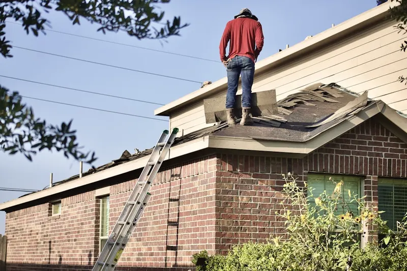 Professional roofer working on a residential roof in Cocoa Isles Country Club